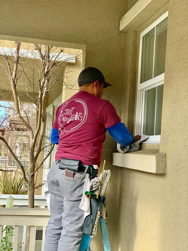 man cleaning window sill